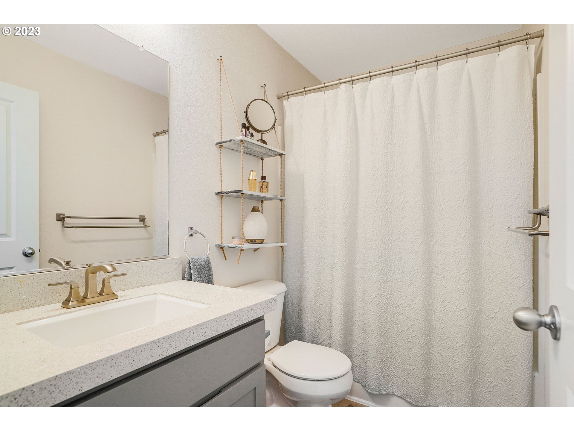 14930 Southwest Conor Circle Beaverton, OR 97006 - Photo 19 of 29 a bathroom with a sink a toilet a mirror and shower curtain