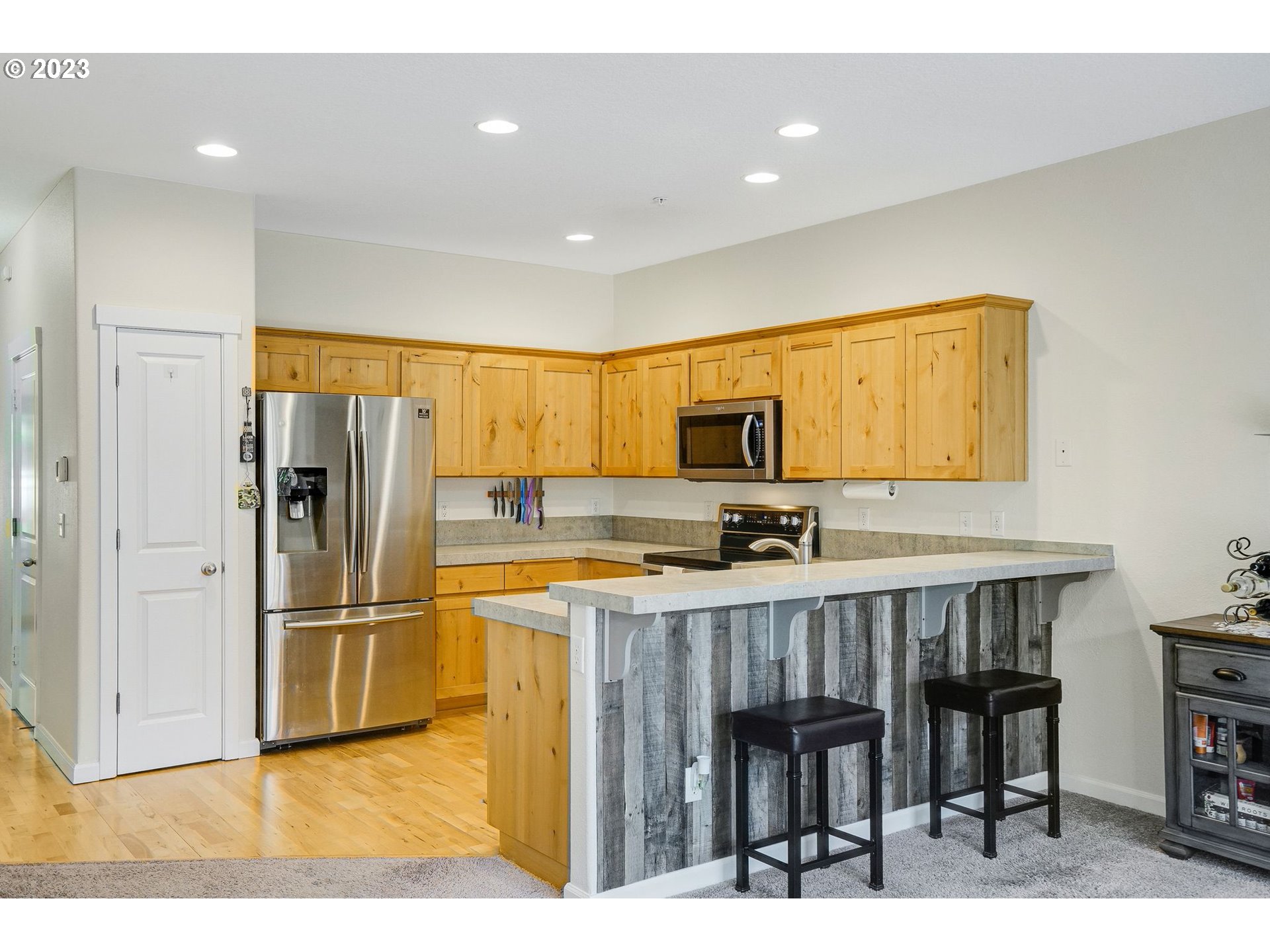 14930 Southwest Conor Circle Beaverton, OR 97006 - Photo 5 of 29 a kitchen with stainless steel appliances a refrigerator and a stove top oven