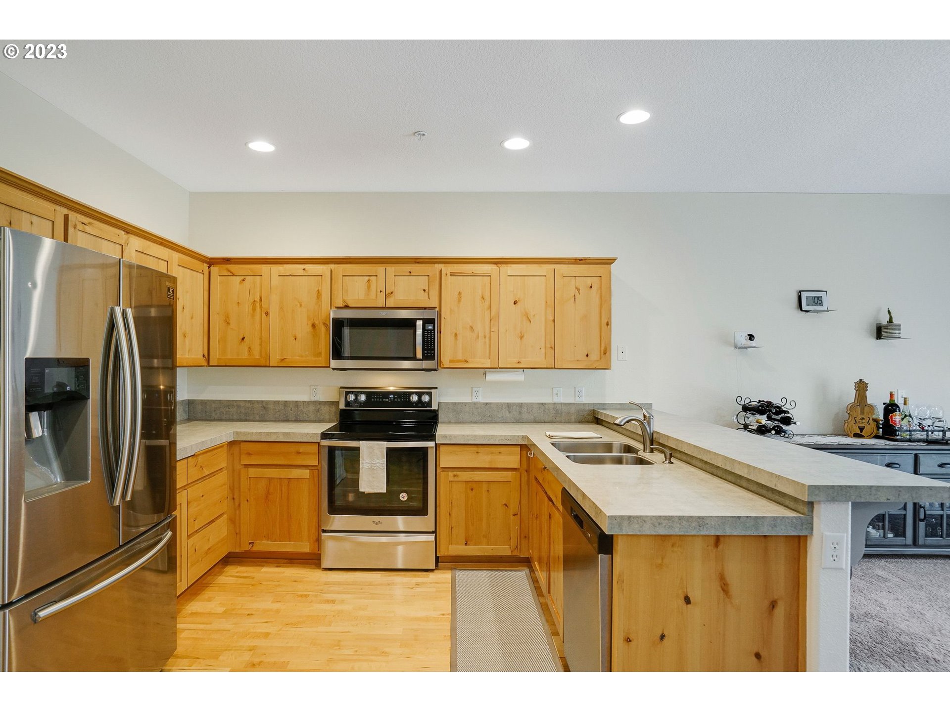 14930 Southwest Conor Circle Beaverton, OR 97006 - Photo 6 of 29 a kitchen with kitchen island a sink appliances and cabinets