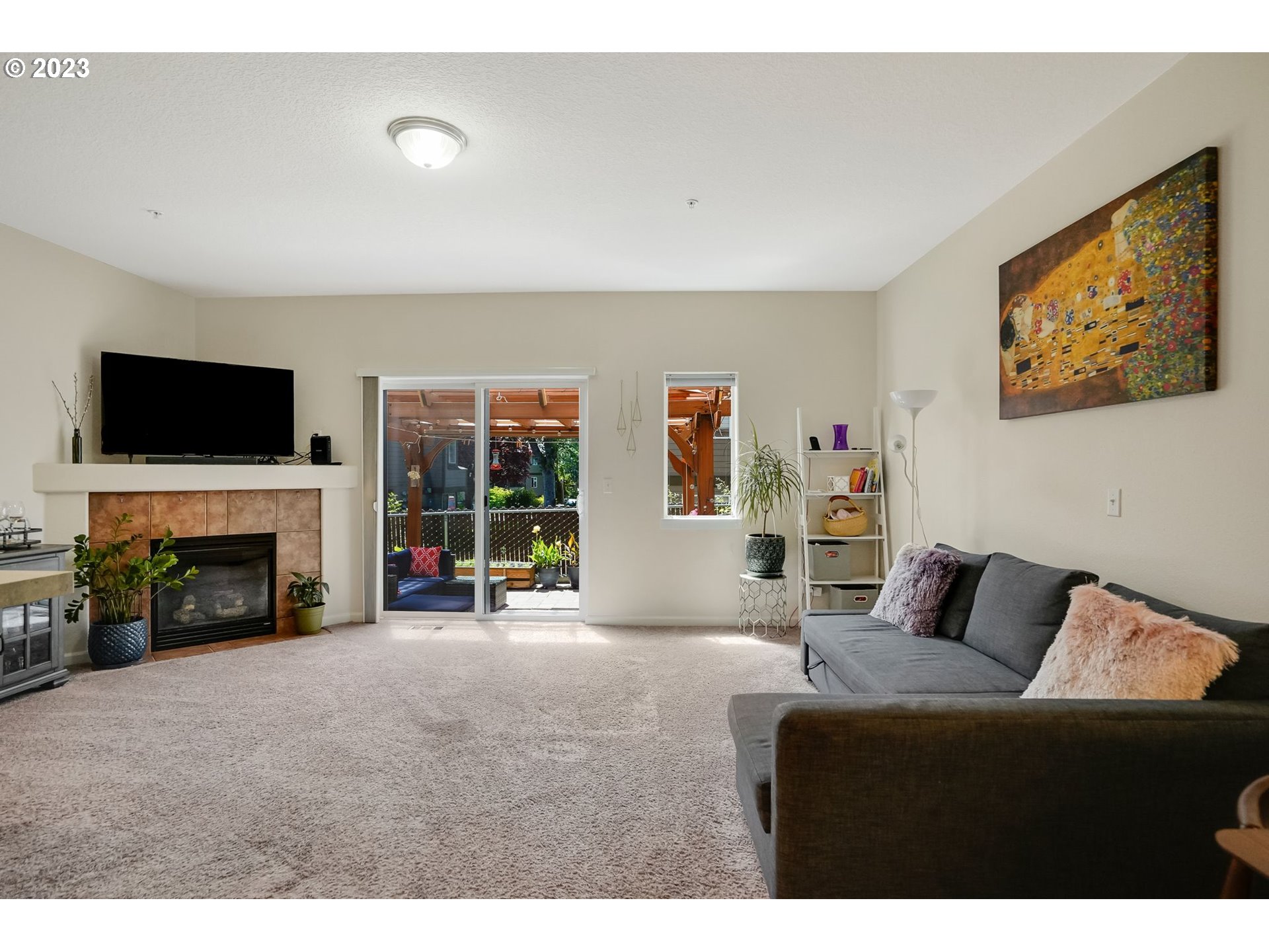 14930 Southwest Conor Circle Beaverton, OR 97006 - Photo 7 of 29 a living room with furniture a fireplace and a flat screen tv