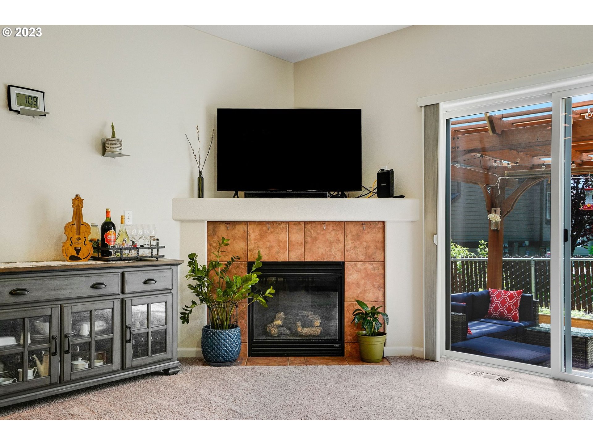 14930 Southwest Conor Circle Beaverton, OR 97006 - Photo 8 of 29 a living room with furniture a flat screen tv and a fireplace