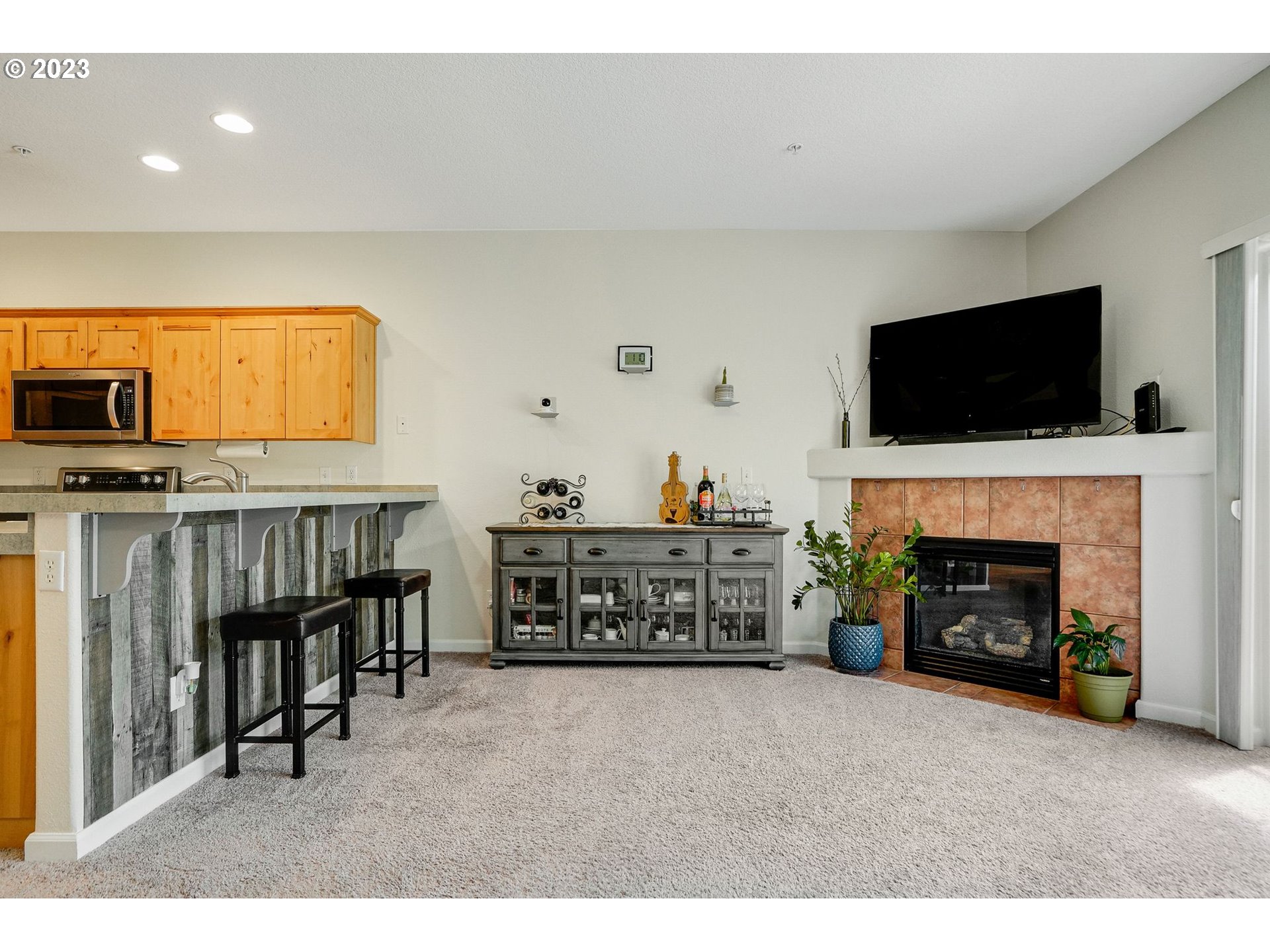 14930 Southwest Conor Circle Beaverton, OR 97006 - Photo 9 of 29 a living room with furniture a flat screen tv and a fireplace