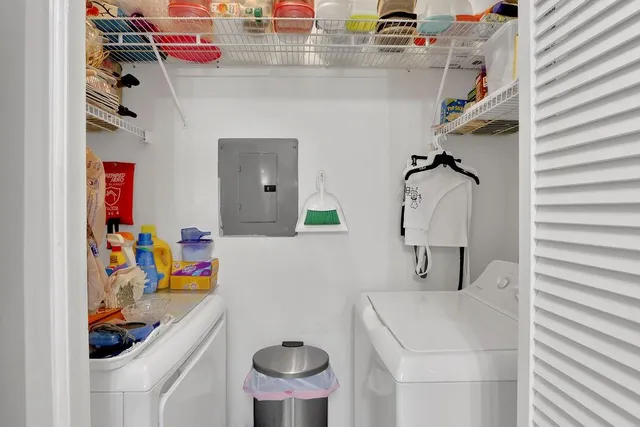 a utility room with a refrigerator and washer
