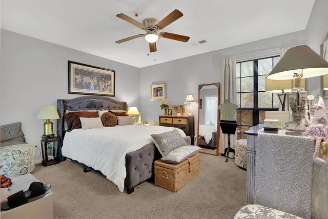 a bedroom with a bed couch and window