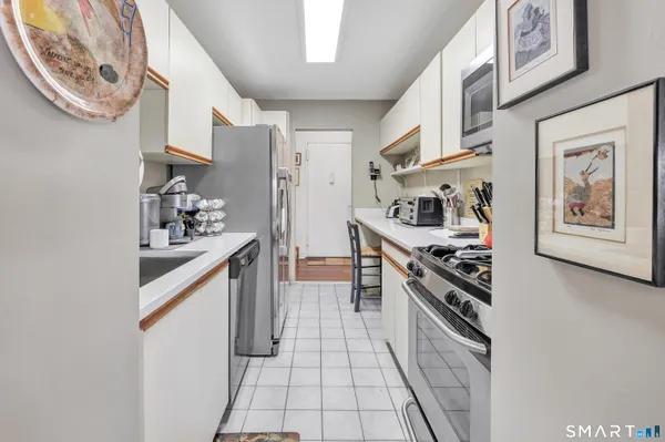 a kitchen with stainless steel appliances granite countertop a stove and cabinets