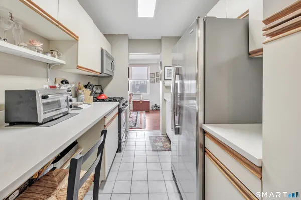 a kitchen with a refrigerator a sink and cabinets