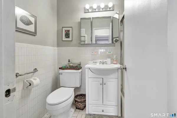 a bathroom with a sink and mirror with toilet