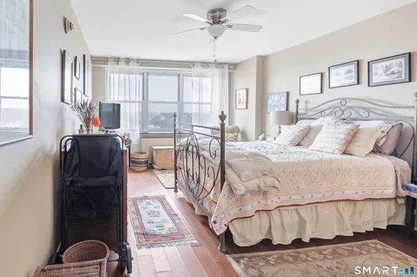 a bed sitting in a bedroom next to a window