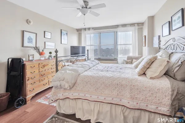 a bedroom with a bed and wooden floor