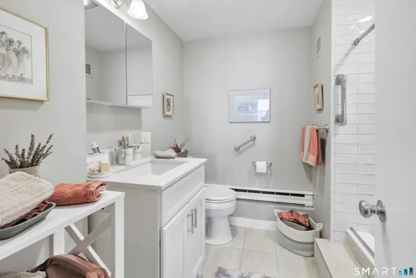 a bathroom with a sink toilet and a mirror