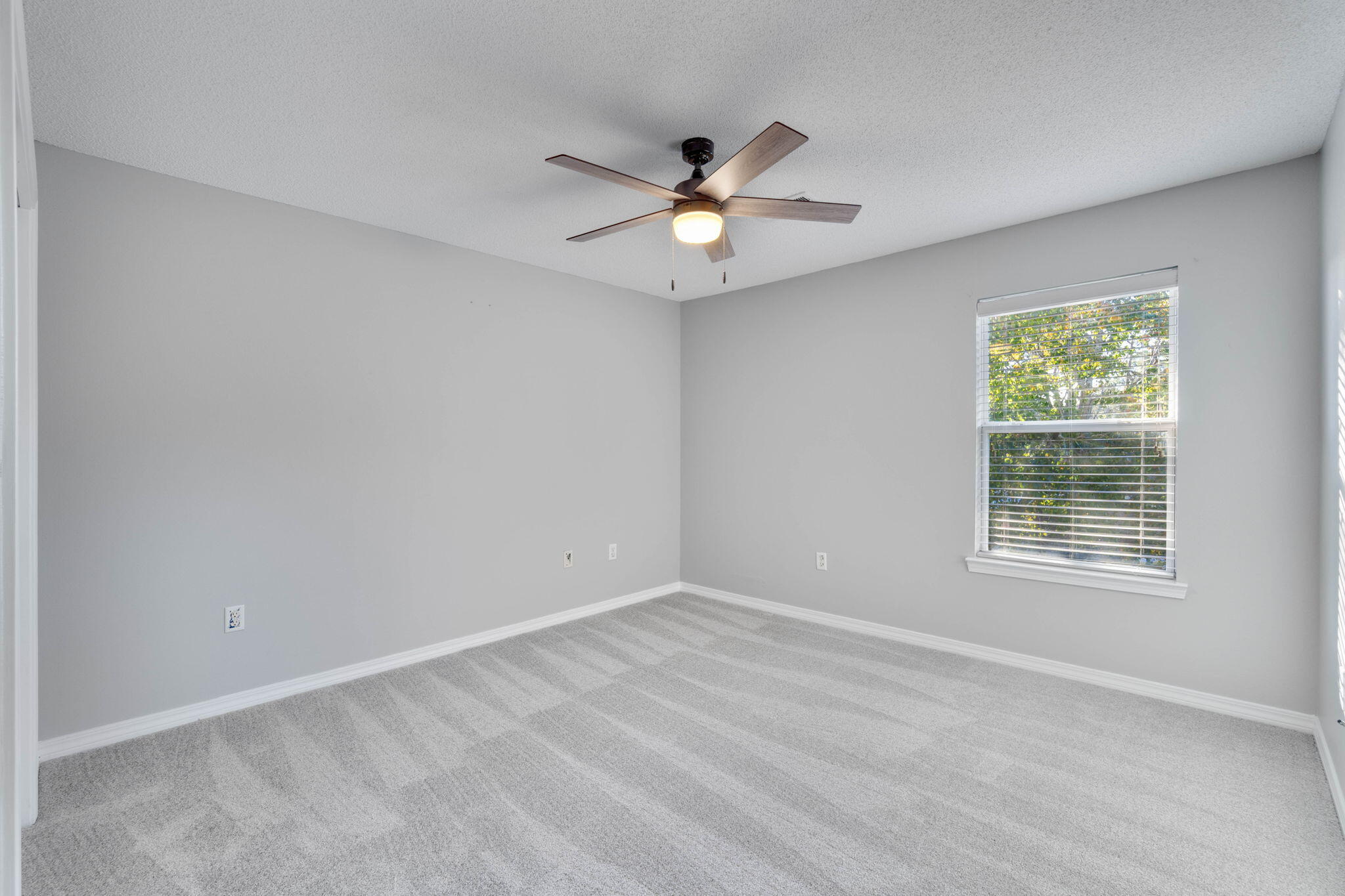 2145 Tom Street Navarre, FL 32566 - Photo 16 of 22 an empty room with a window and a fan