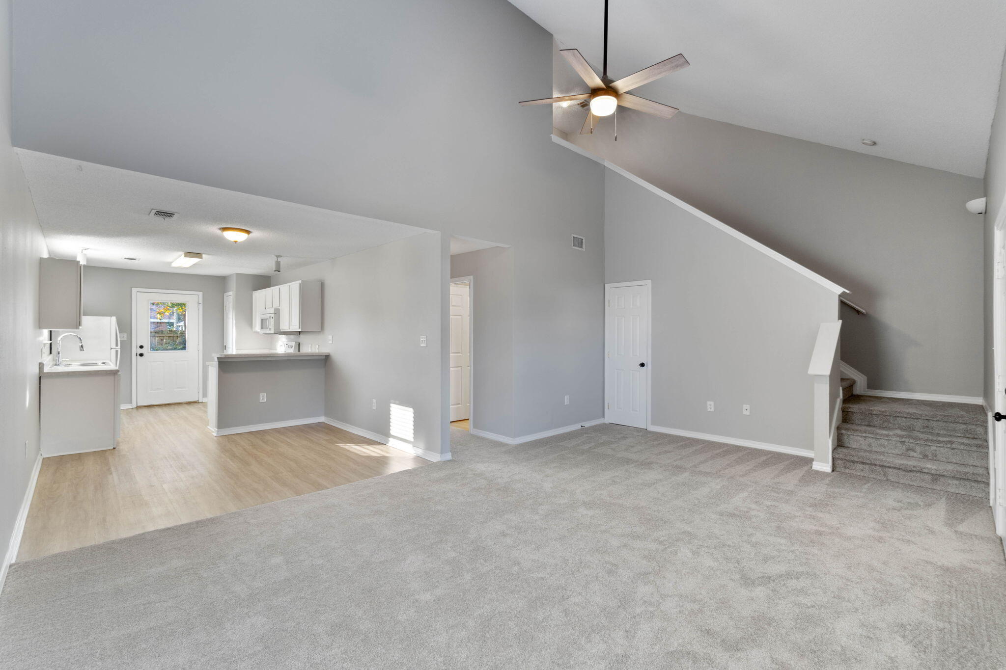 2145 Tom Street Navarre, FL 32566 - Photo 2 of 22 en view interior of a house with a ceiling fan and kitchen view