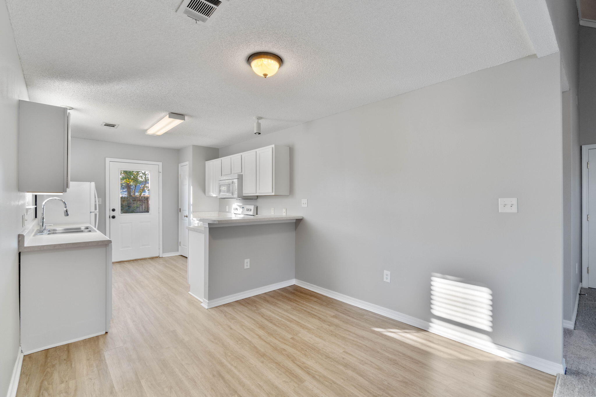 2145 Tom Street Navarre, FL 32566 - Photo 4 of 22 a view of kitchen with wooden floor