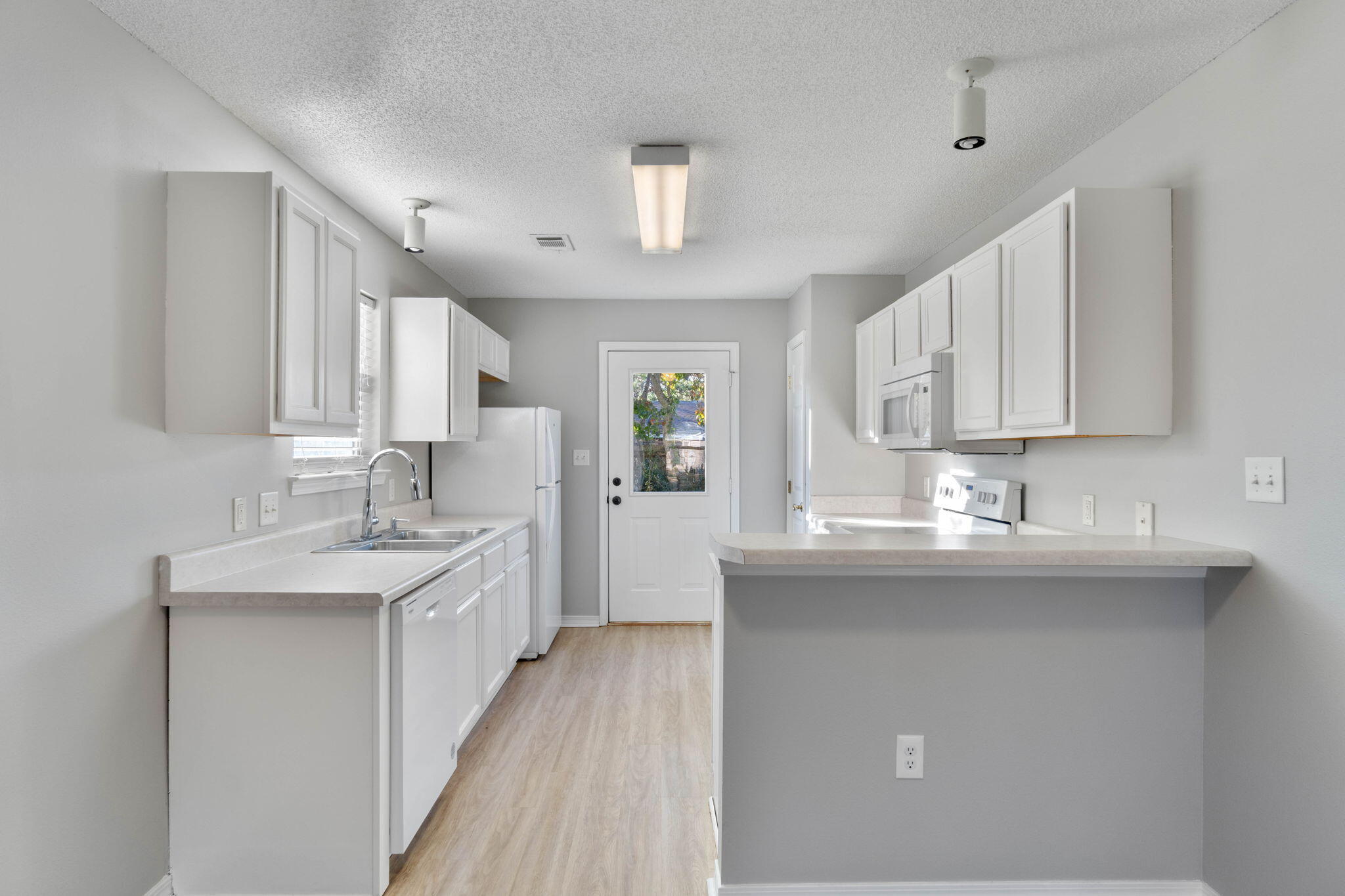 2145 Tom Street Navarre, FL 32566 - Photo 5 of 22 a kitchen with stainless steel appliances granite countertop a sink stove and cabinets