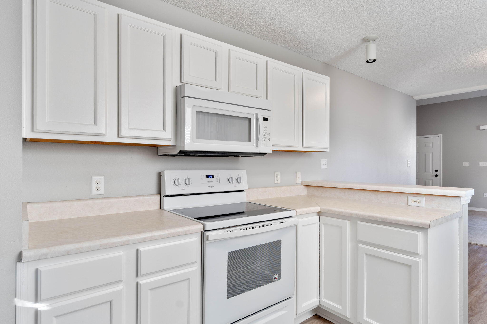 2145 Tom Street Navarre, FL 32566 - Photo 7 of 22 a kitchen with white cabinets and white appliances