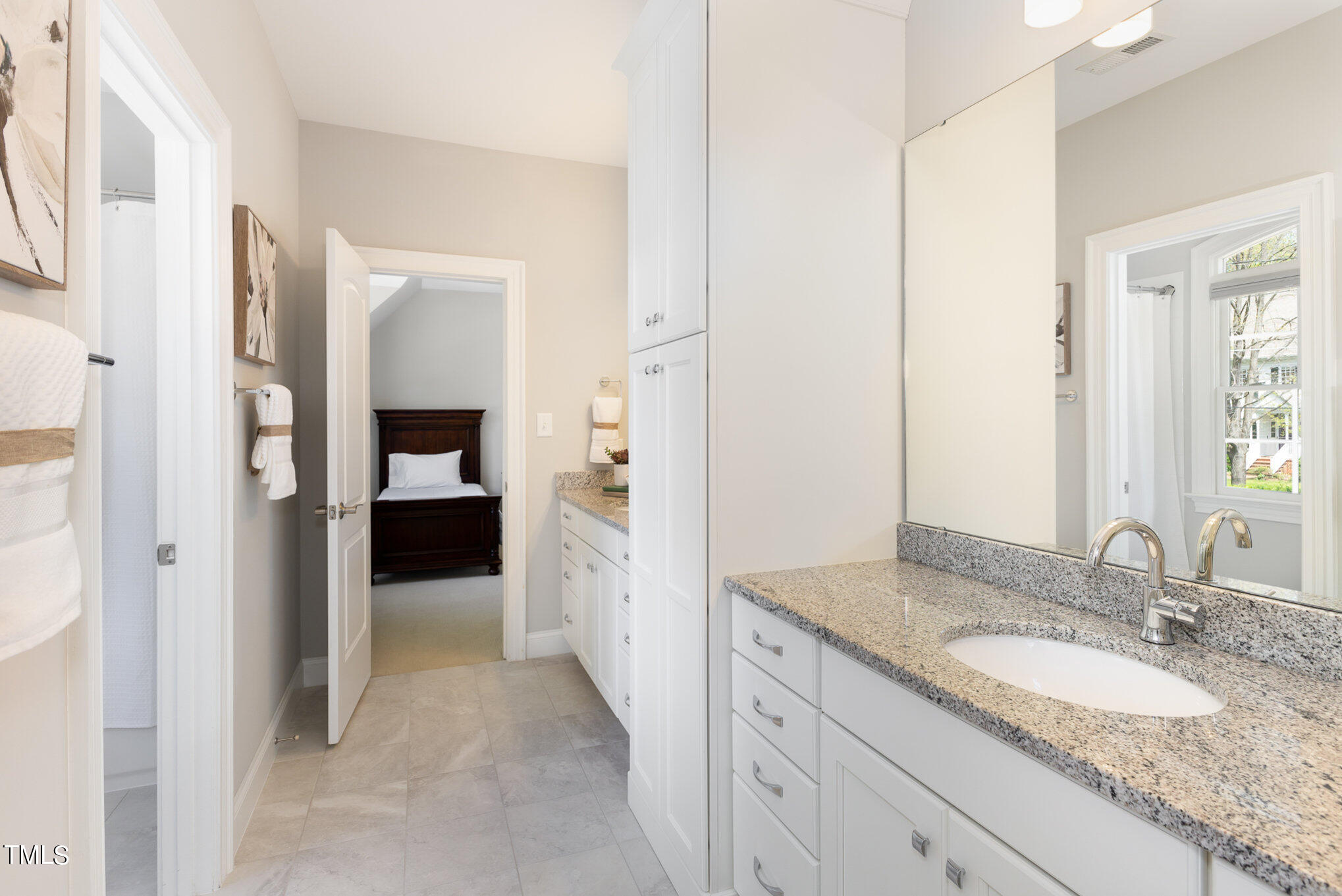 3311 Churchill Road Raleigh, NC 27607 - Photo 12 of 15 a en suite bathroom with a granite countertop sink and a mirror