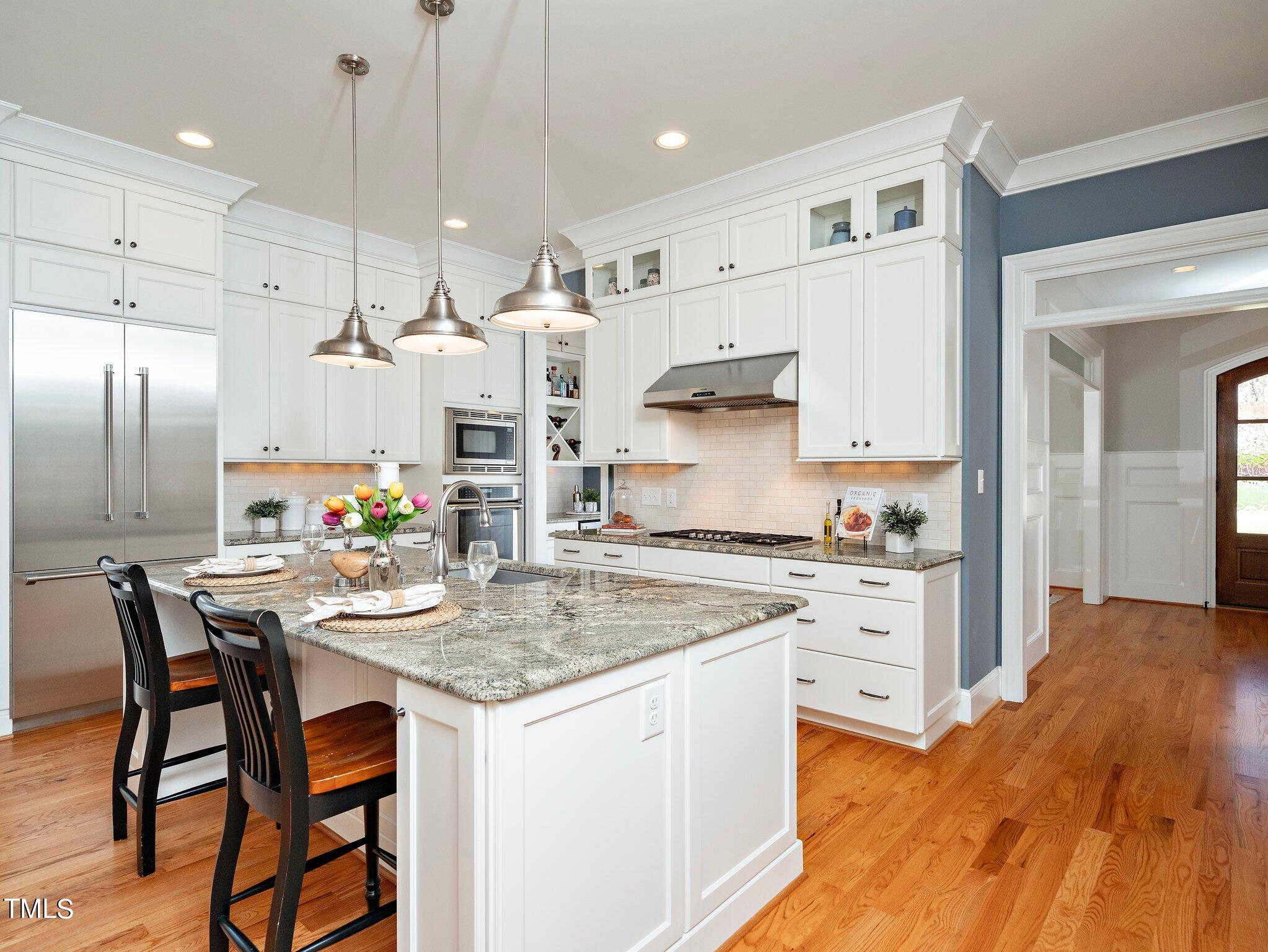 3311 Churchill Road Raleigh, NC 27607 - Photo 3 of 15 a kitchen with stainless steel appliances granite countertop a stove top oven a sink refrigerator and cabinets