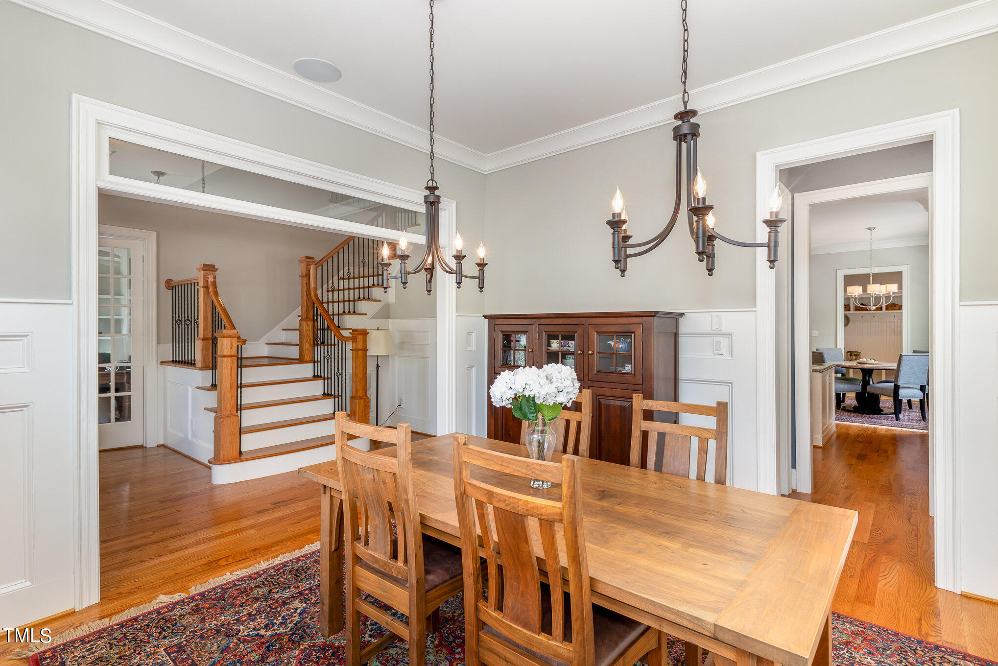 3311 Churchill Road Raleigh, NC 27607 - Photo 4 of 15 a view of a dining room and livingroom with furniture wooden floor a chandelier
