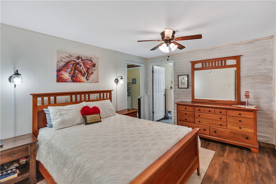 110 Lakeshore Lane Seneca, SC 29678 - Photo 15 of 50 This restful primary bedroom features warm wood tones and bright white walls, creating a cozy and inviting atmosphere.