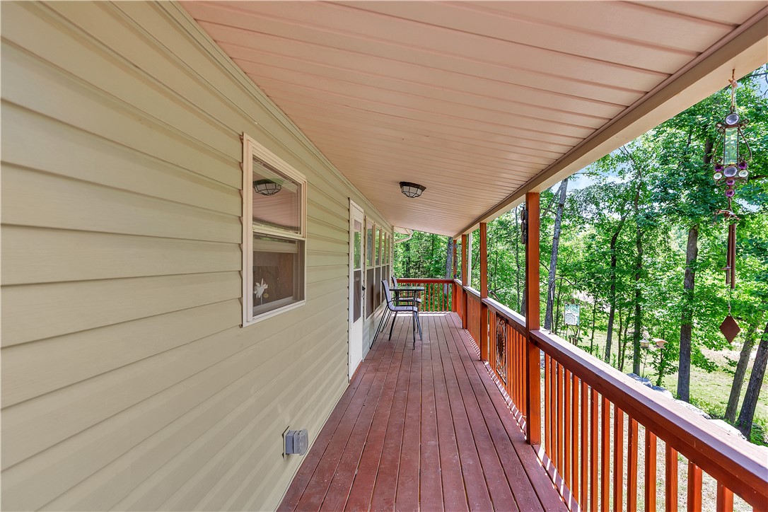 110 Lakeshore Lane Seneca, SC 29678 - Photo 27 of 50 This inviting side porch offers a tranquil retreat with expansive views of the surrounding natural landscape & wildlife.