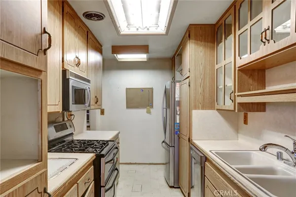 a kitchen with stainless steel appliances granite countertop a sink and a stove