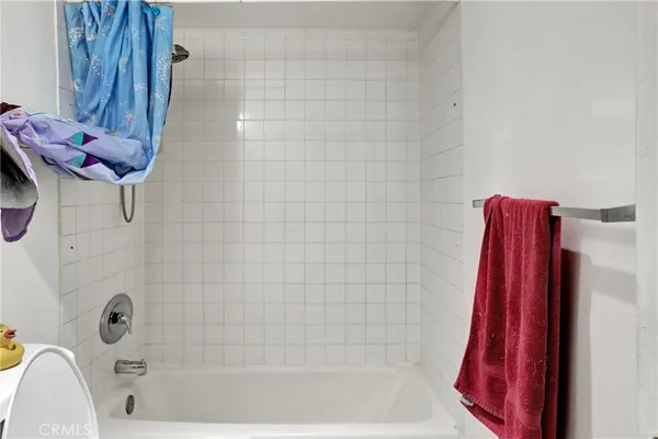 a bathroom with a granite countertop toilet a sink and bathtub