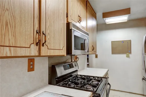 a kitchen with a stove a microwave and sink