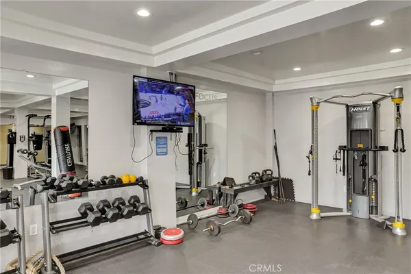 a room with gym equipment and windows