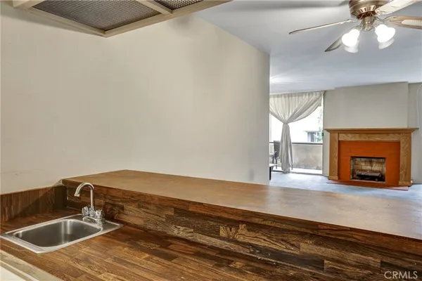 a kitchen with granite countertop a sink and a stove