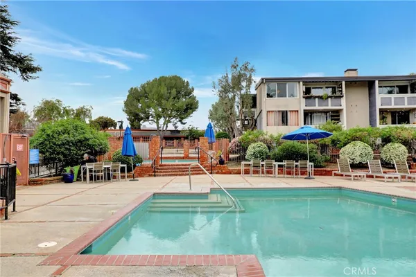 a front view of a house with swimming pool garden and patio
