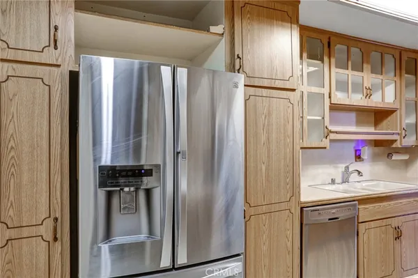 a kitchen with stainless steel appliances a refrigerator and a sink