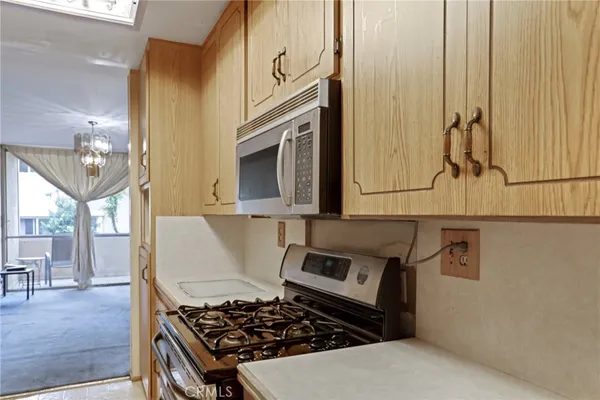 a kitchen with stainless steel appliances a stove a microwave and cabinets