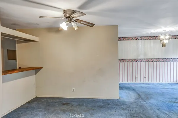 a view of a livingroom with a ceiling fan and window