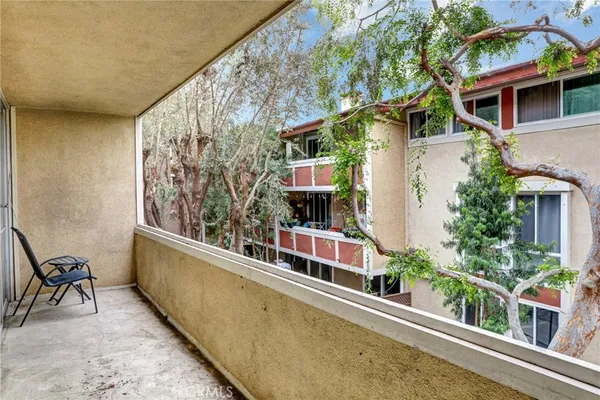 a view of balcony with furniture