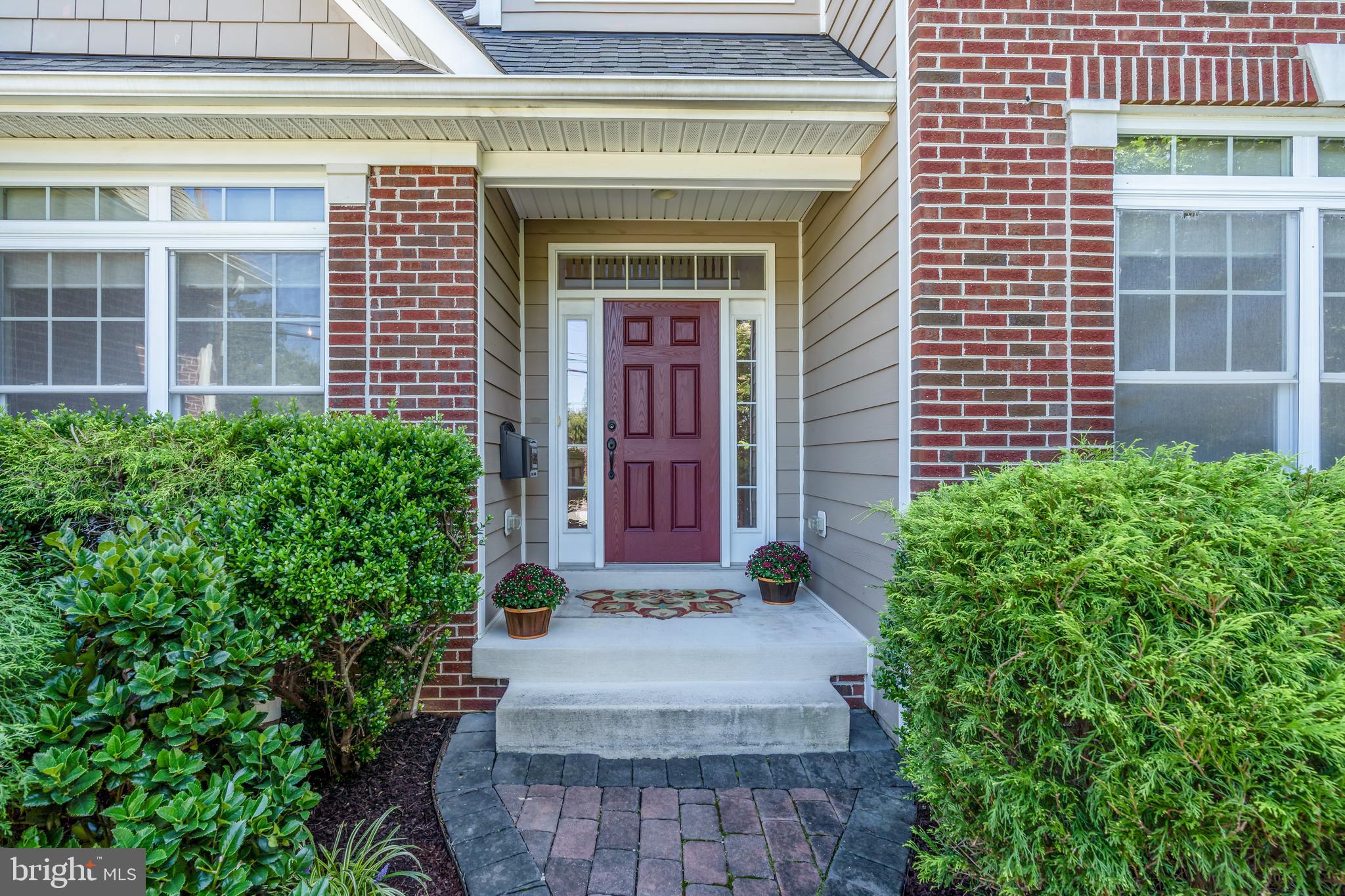 Front door features transom and side lights.