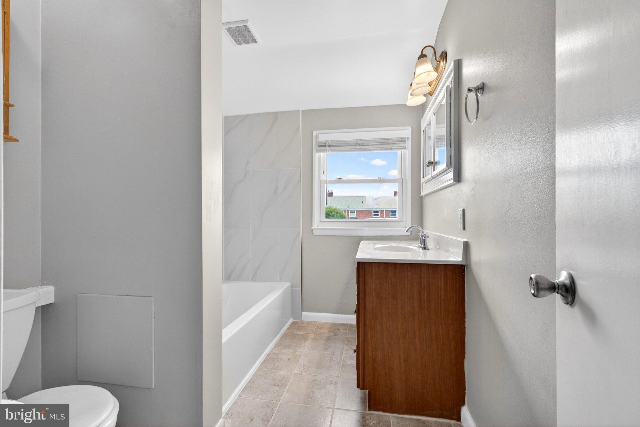 7729 Charlesmont Road Baltimore, MD 21222 - Photo 26 of 38 Bright and airy modern bathroom retreat.