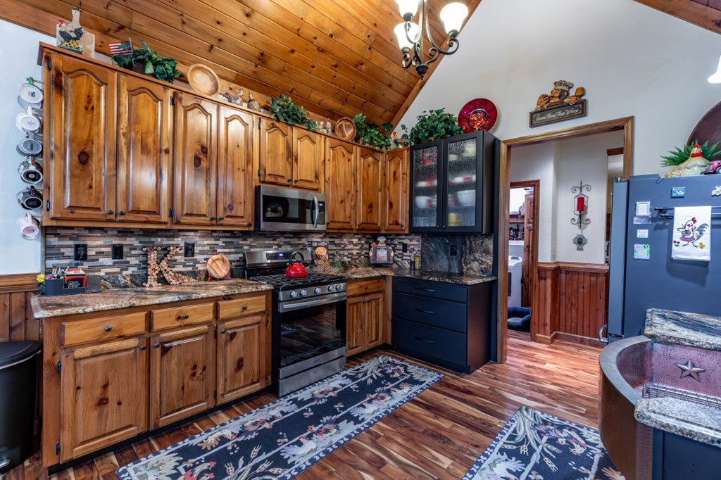159 Apple Blossom Road Blairsville, GA 30512 - Photo 13 of 56 a kitchen with wooden cabinets and stainless steel appliances