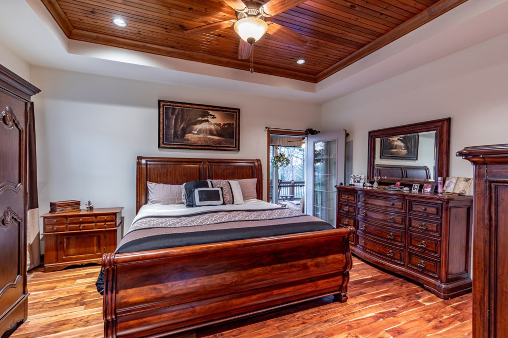 159 Apple Blossom Road Blairsville, GA 30512 - Photo 15 of 56 a bedroom with bed and wooden floor