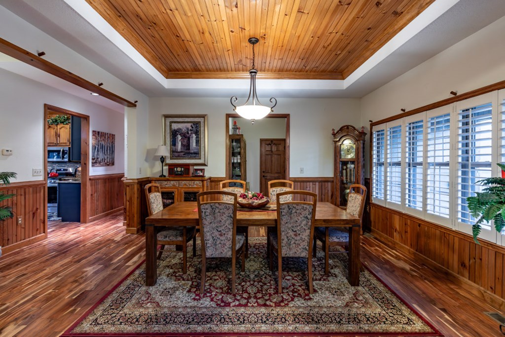 159 Apple Blossom Road Blairsville, GA 30512 - Photo 8 of 56 a dining room with wooden floor a chandelier a wooden table and chairs