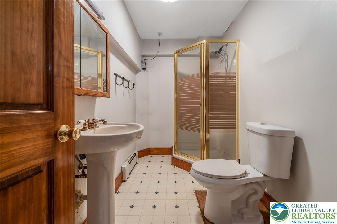 465 Raubsville Road Easton, PA 18042 - Photo 54 of 60 Located in the walk-out basement. A compact full bath features a pedestal sink, shower stall, and toilet.