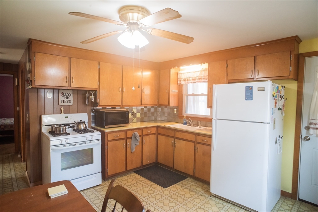 94 David Street Springfield, MA 01104 - Photo 6 of 11 a kitchen with a stove a sink and a refrigerator