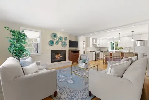 a living room with furniture fireplace and a fireplace