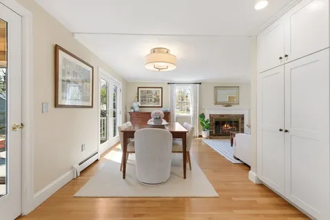 a living room with furniture a fireplace and a window
