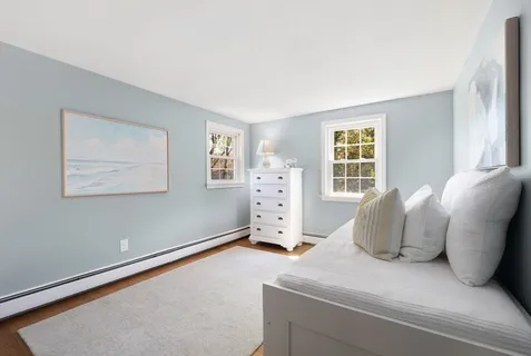 a spacious bedroom with a bed and a window
