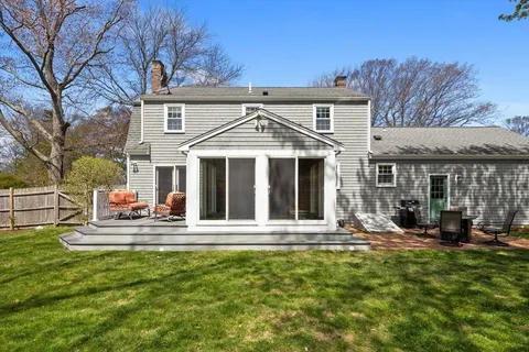 a front view of a house with a yard table and chairs