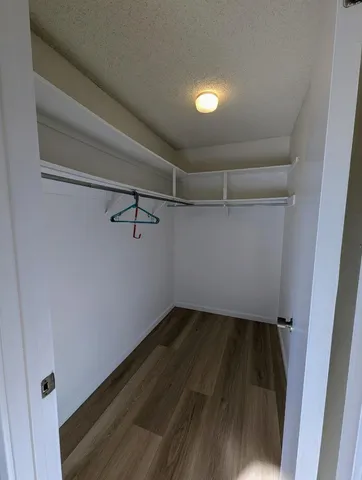 a view of a room with wooden floor