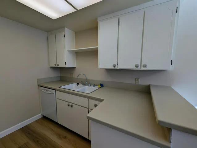 a kitchen with stainless steel appliances white cabinets and a sink