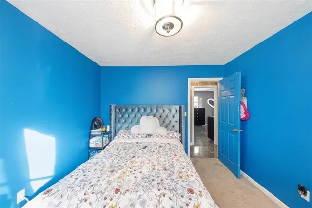 a bedroom with a bed and a chair