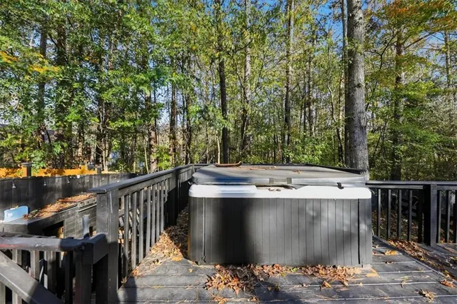 a view of a roof deck with two couches and wooden fence