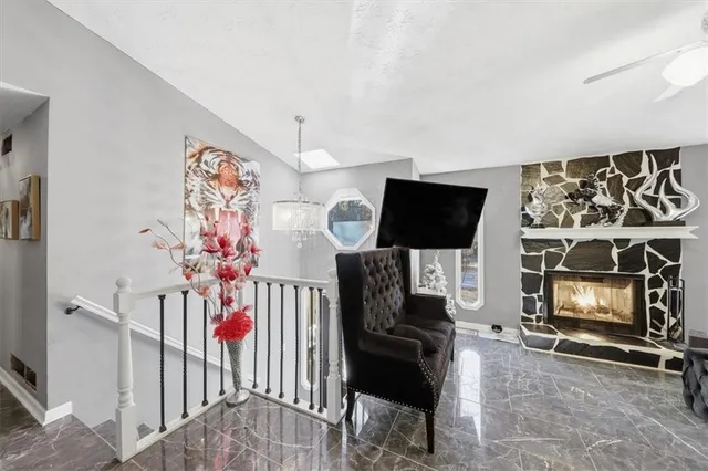 a livingroom with furniture a flat screen tv and a fireplace